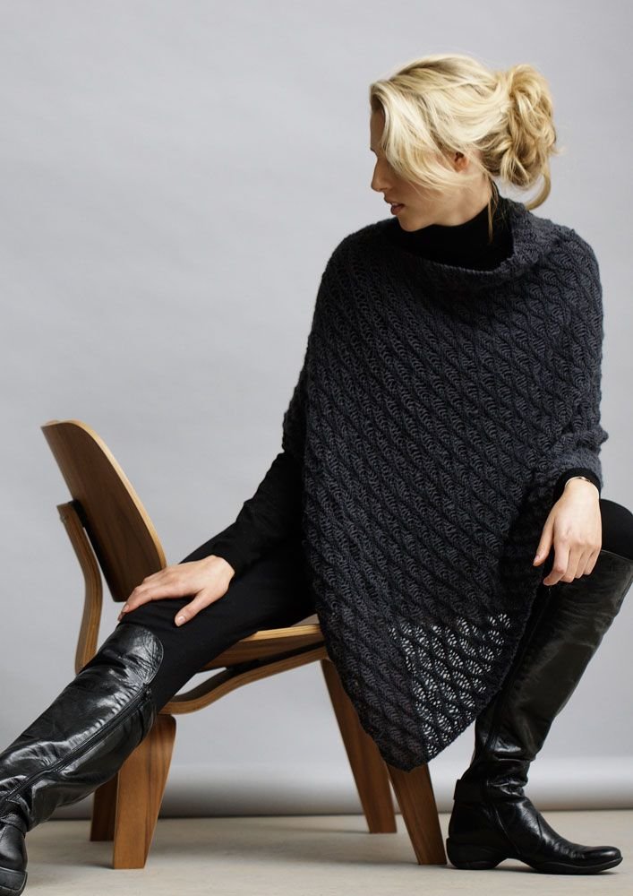 This poncho is made from a simple rectangle, folded and sewn along one edge, with a gap remaining at one side for neck opening.